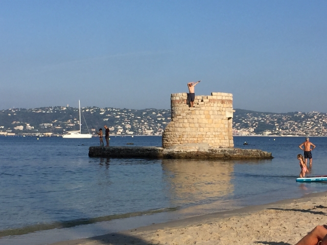 Luc playing the "king of the castle" at the beach