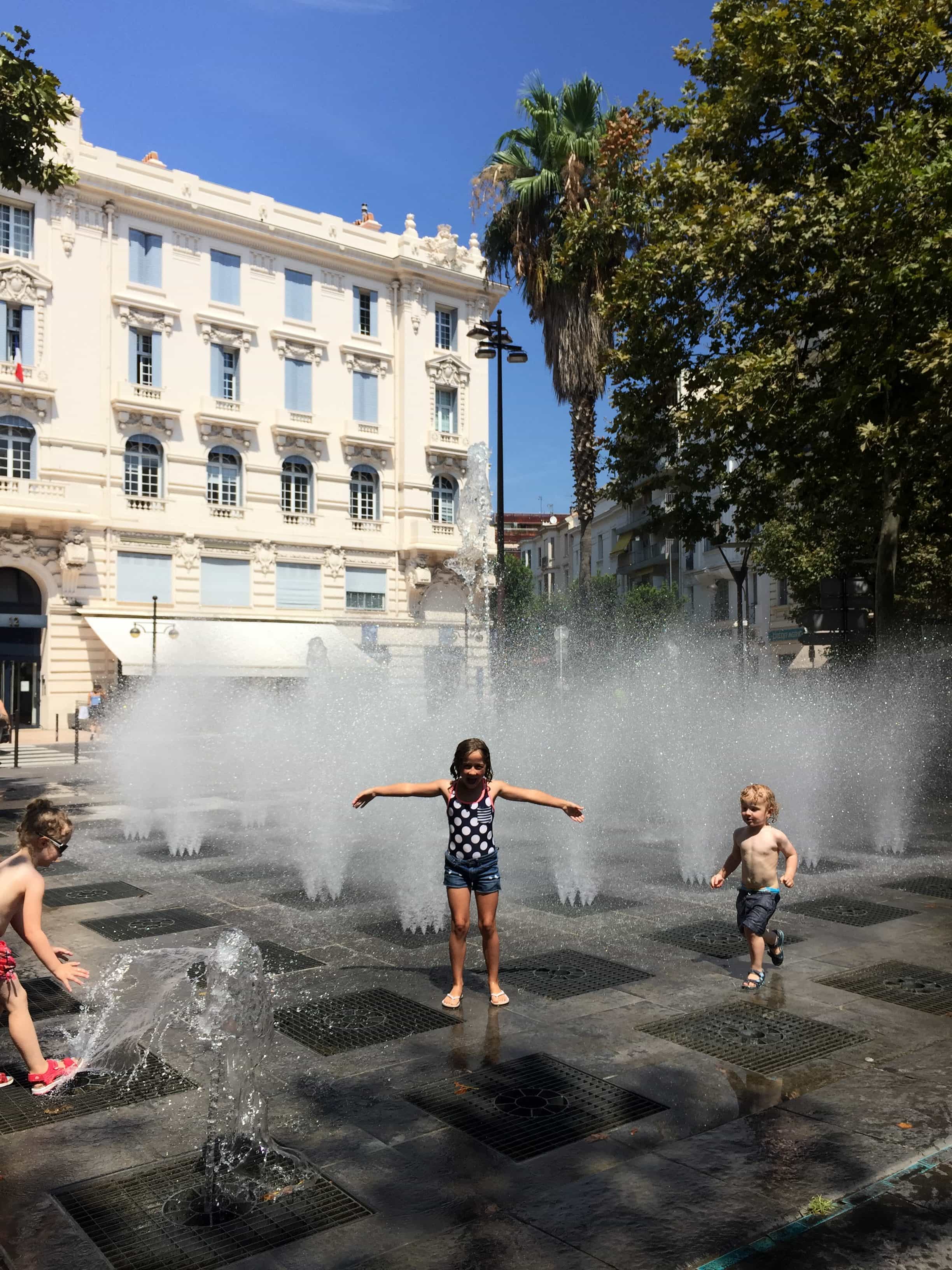 Cooling off at the inground fountains in Antibes